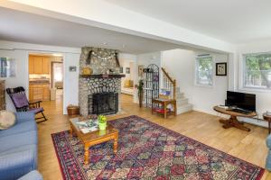 a living room with a blue couch and a fireplace at Charming Old Saybrook Home Half-Mi to Sand and Sea! in Old Saybrook