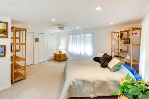 a bedroom with a bed and a book shelf at Charming Old Saybrook Home Half-Mi to Sand and Sea! in Old Saybrook