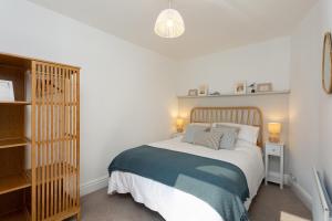 a bedroom with a bed and a book shelf at Low Tide @ Filey. Close to Beach. Dog Friendly. in Filey