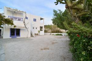 a large white house with a driveway at George in Galissas