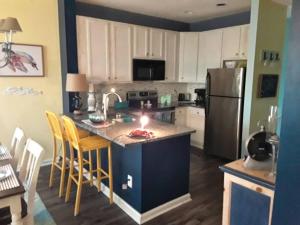 a kitchen with a kitchen island with a candle on it at Legends Golf Beachy Condo in Myrtle Beach