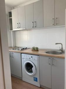 a kitchen with a washing machine and a sink at ZEN studio in the heart of Bucharest in Bucharest