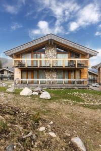 a house with a large porch on the side of it at Apartmán SAFFRON Chalet JASNÁ in Demanovska Dolina