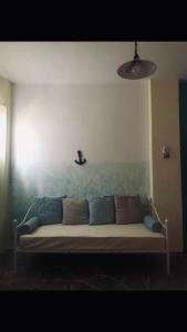 a couch in a room with a wall at The View Spot in Serifos Chora +3 photos