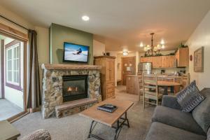 a living room with a fireplace and a kitchen at Expedition Station 8622 in Keystone