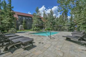 a patio with benches and a swimming pool at Expedition Station 8622 in Keystone