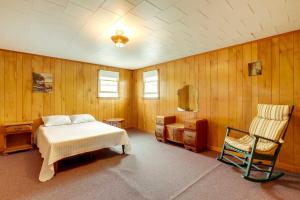 a bedroom with a bed and a chair in it at Family-Friendly Vacation Rental on Salisbury Beach in Salisbury