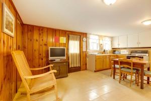 a kitchen with wooden walls and a table and a television at Pet-Friendly Vacation Rental in the Salisbury Area in Salisbury