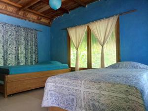 A bed or beds in a room at Tambo Marina Eco Hostal