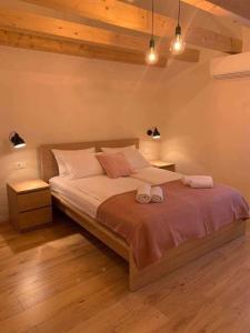 a bedroom with a large bed with two towels on it at Holiday home Ana in Cres