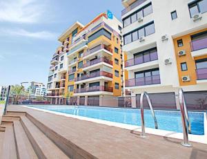 a swimming pool in front of some buildings at SOPHIA LAKE VIEW SUITE in Mamaia