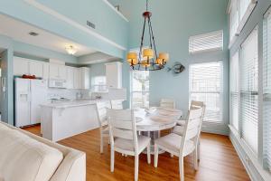 a kitchen and dining room with a table and chairs at Serenity On The Bay in Fairhope