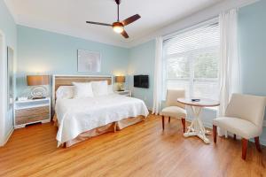 a bedroom with a bed and a table and chairs at Serenity On The Bay in Fairhope