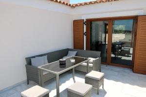a patio with a table and chairs and a dining room at Villa Ariadne in Athens