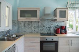 a kitchen with a sink and a stove top oven at Villa Theodora View Apartments Klio in Corfu Town +12 photos