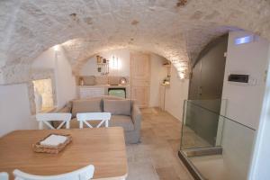 a living room with a couch and a table at SPA homes by Pcb in Ostuni