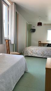 Postel nebo postele na pokoji v ubytování WEAA Hotel