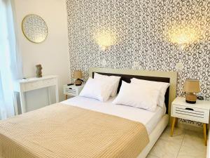 a bedroom with a bed with two night stands and two lamps at Skopelos Inn in Stafylos