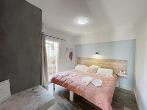 a bedroom with a bed with two towels on it at Miramare Apartments in Platanias