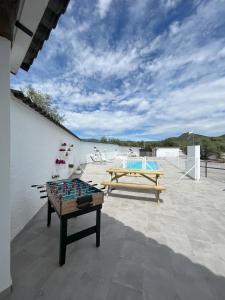 a ping pong table on a patio with a pool at El Gallinero in Almoharín