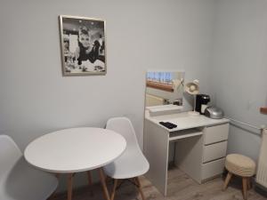 a small room with a white desk and a table and chairs at Romeo i Julia in Łagów +59 photos