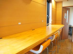 una sala de conferencias con una larga mesa de madera y sillas en HataraColiving - Vacation STAY 22651v en Chichibu