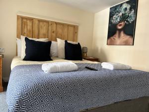 a bedroom with a bed with two pillows on it at Bay Horse in York