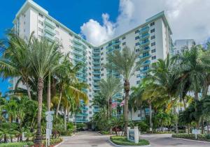 a large building with palm trees in front of it at Miami Hollywood Gorgeous 2BD Awesome Ocean View in Hollywood