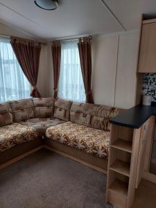 a living room with a couch and a table at 6 berth pet friendly caravan on Sandy Glade (John Fowlers) Brean in Berrow