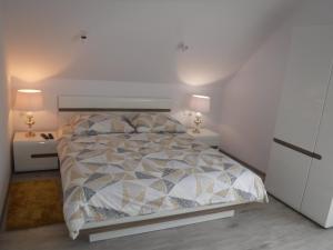 a bedroom with a bed and two night stands at Villa Luis in Dziwnów