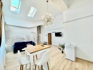 a dining room and living room with a table and chairs at Residence Odaile #9 in Otopeni