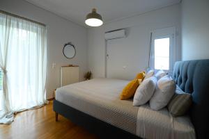 A bed or beds in a room at Marine Luxury Apartment Kalamata