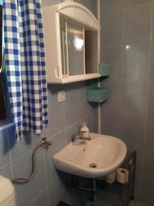a bathroom with a sink and a cabinet at Cottage Lepena in Soča +17 photos