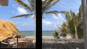 a view of the beach from a window at Orchid Beach House Adults Only in Tulum
