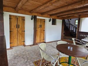 a patio with tables and chairs and wooden ceilings at Casa cu Turn in Sărata-Monteoru +14 photos