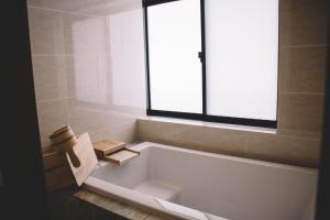 a white bath tub in a bathroom with a window at WASEIDOU ZEN - Vacation STAY 17216v in Kobe