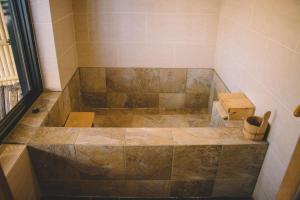 a bathroom with a shower with a large tub at WASEIDOU ZEN - Vacation STAY 19522v in Kobe