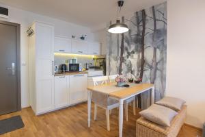 a kitchen with a table and chairs in a room at Cardak u Sumi (Forest house) in Kopaonik