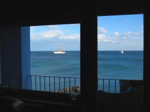 a view of the ocean from a room with two windows at Hotel Palladio in Giardini Naxos