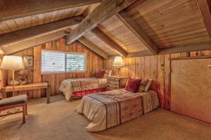 a bedroom with two beds in a log cabin at Killdeer - Unit 6 in Sunriver +33 photos