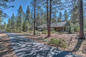 a road leading to a house in the woods at Killdeer - Unit 6 in Sunriver