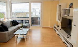 a living room with a couch and a table at Apartment am Kurpark in Bad Segeberg