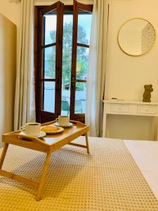 a coffee table in a room with a window at Skopelos Inn in Stafylos
