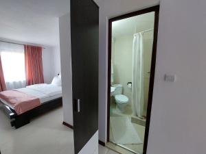 a bathroom with a bed and a toilet and a mirror at Casa Nico Nelu Duplex in Arieşeni +68 photos