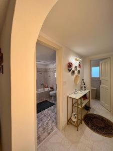 an archway leading to a bathroom with a tub at Lux Mykonos house in Agios Stefanos