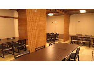 a dining room with tables and chairs in it at Shimaonsen AYAMEYA Ryokan - Vacation STAY 20626v in Shima