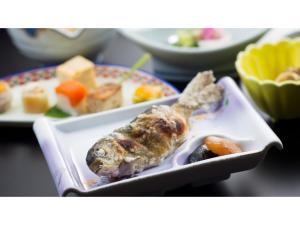 a plate of food with a fish on a table at Shimaonsen AYAMEYA Ryokan - Vacation STAY 20626v in Shima