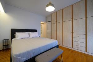 A bed or beds in a room at Marine Luxury Apartment Kalamata