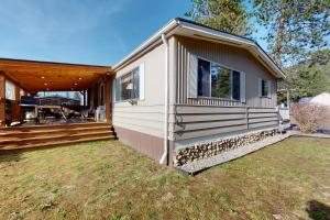 a tiny house with a porch and a deck at Lazy Dayz Cottage in Christina