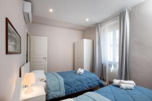 Кровать или кровати в номере Casa mia a Nervi